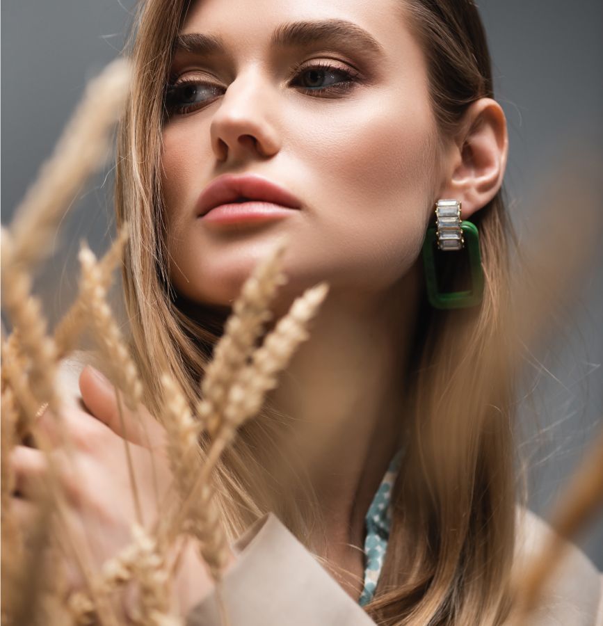 Dedham Hydrafacial model holding flowers with soft, natural lighting.