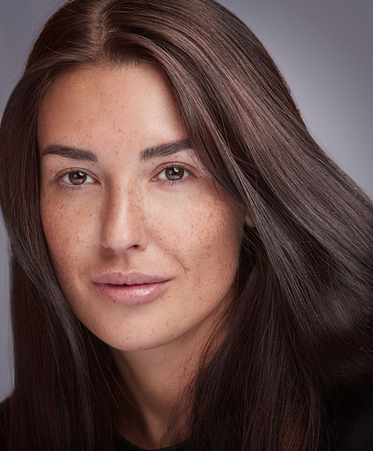 Portrait of a woman with long brown hair.