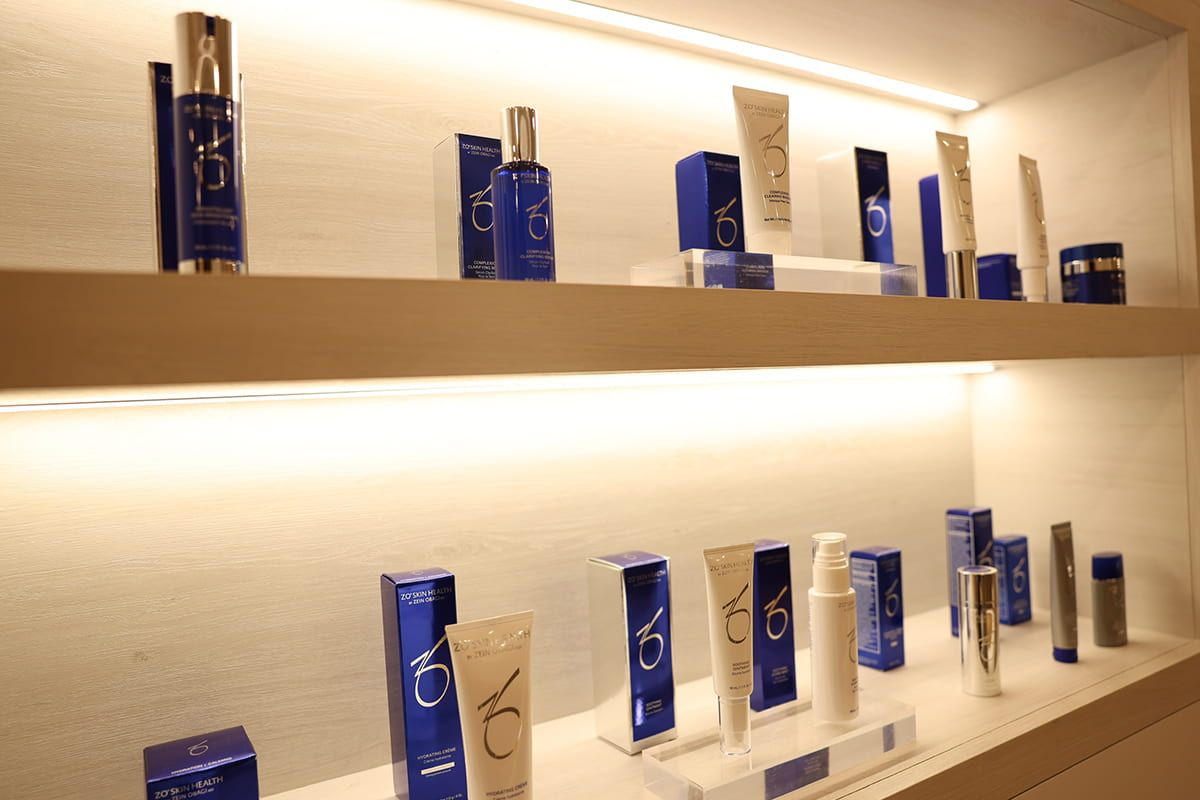 Skincare products displayed on lighted shelves.