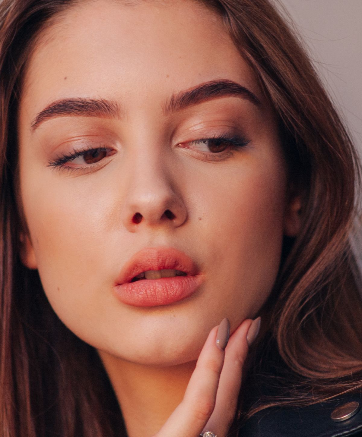 Close-up of a Dedham lip filler model's face with natural makeup.