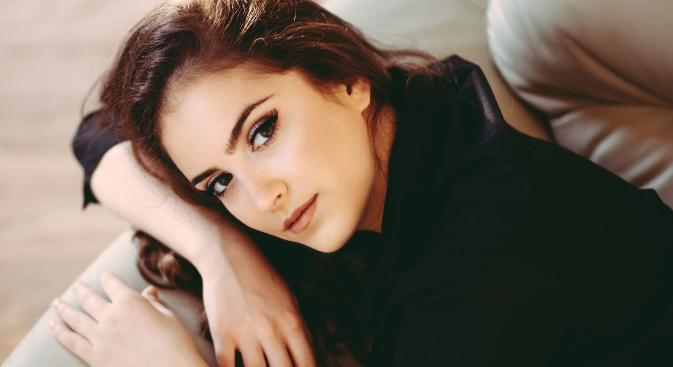 Portrait of a woman resting on a sofa.